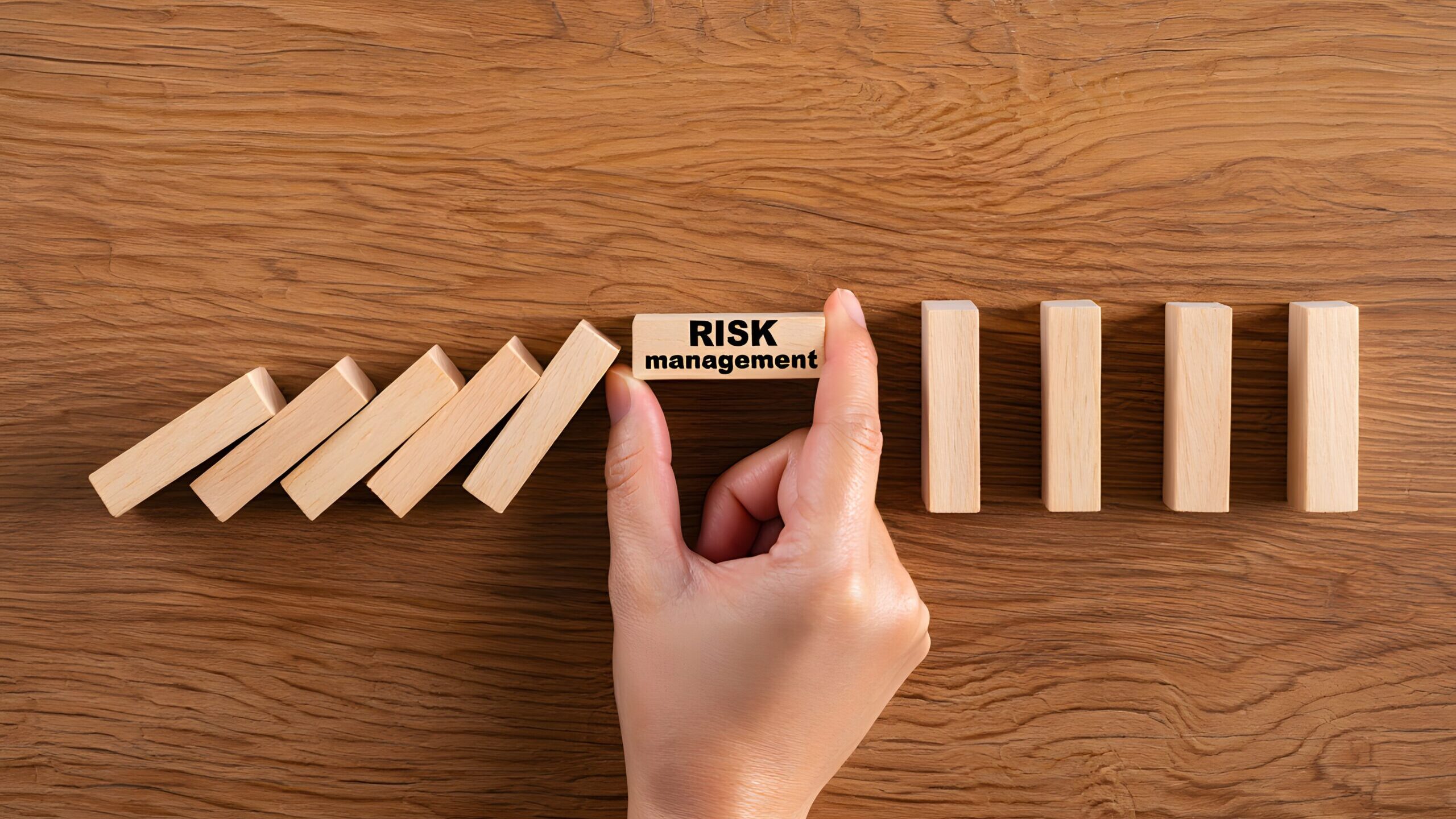 Hand Stopping Domino Effect with Risk Management Block